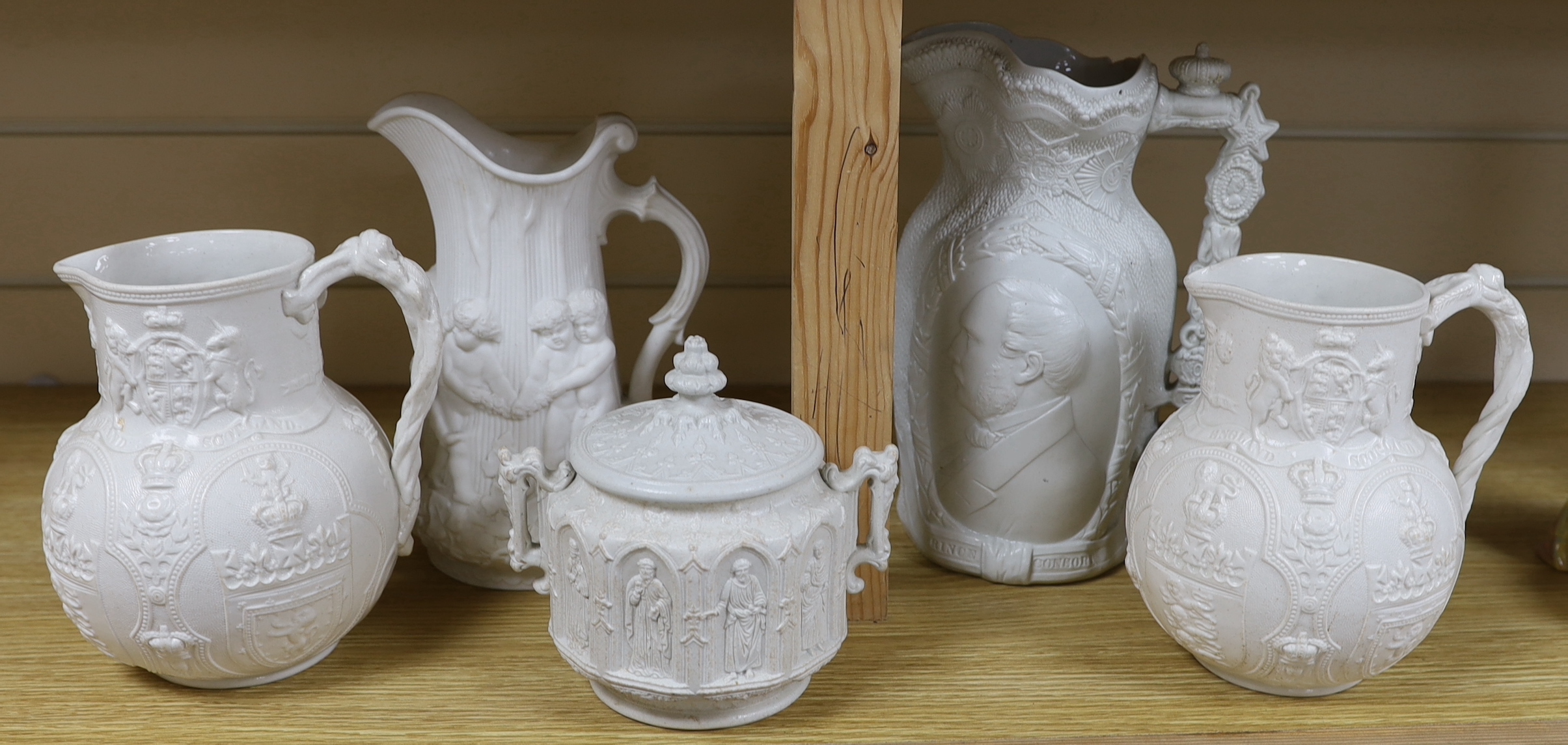 A pair of William Brownfield Parian jugs, moulded with armorials for England, Scotland and Wales, two other Parian ware jugs and a lidded sugar bowl (5), tallest jug 27cm high